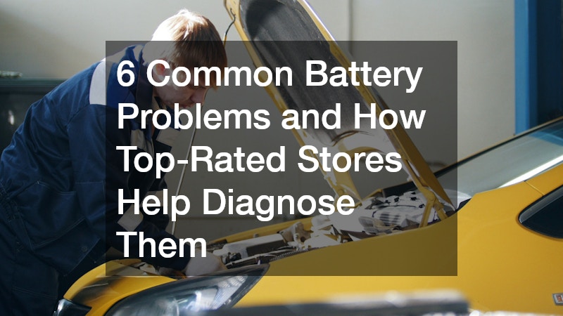 man fixing a car battery issue under an open hood